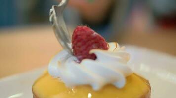 Eating restaurant dessert with sponge cake, meringue and raspberry video