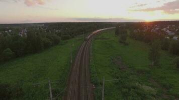 Cargo train crossing countryside at sunset, Russia video