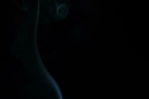 Blue smoke on a dark background photo