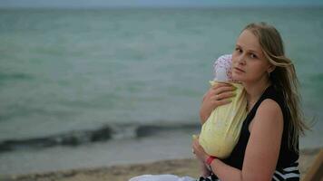 Sad mum with baby near the sea video