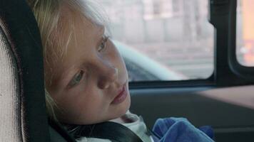 Tired little girl in car safety seat video