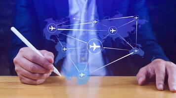 Businessman hand pushing flight booking networking, Hand pressing light blue world map with flight routes airplane, Transportation concept. photo