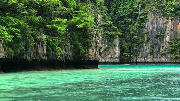 The sea is green with rocky mountains at the Pileh Lagoon Bay, Krabi Province. Beautiful nature video