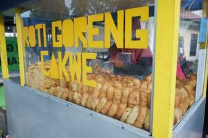 vendor stall with the words cakwe fried bread in English cakwe fried bread. Cakwe is one of the traditional Chinese snacks with a savory taste photo