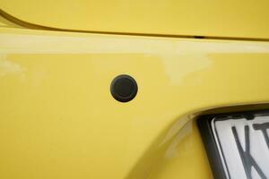 The black circle on the rear car bumper is a reverse sensor or for parking to avoid crashing photo