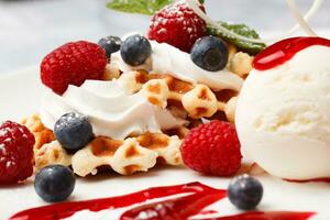 Waffle with cream, ice cream and fresh berries photo