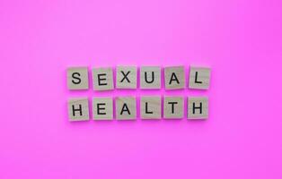 September 26, World Contraception Day, sexual health, minimalistic banner with the inscription in wooden letters photo