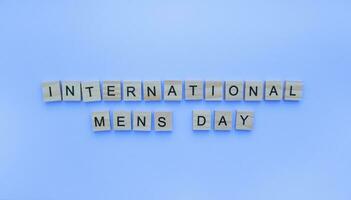 November 18, International Mens Day, IMD, minimalistic banner with the inscription in wooden letters photo