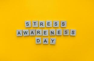 November 2, Stress Awareness Day, minimalistic banner with the inscription in wooden letters photo