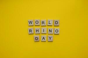 September 22, World Rhino Day, minimalistic banner with the inscription in wooden letters photo