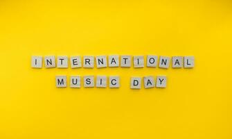 October 1, International Music Day, minimalistic banner with the inscription in wooden letters photo