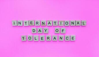 November 16, International Day for Tolerance, minimalistic banner with the inscription in wooden letters photo