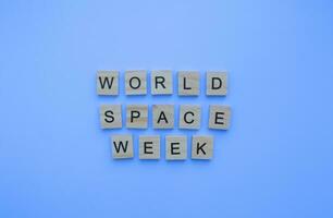 October 4-10, World Space Week, minimalistic banner with the inscription in wooden letters photo