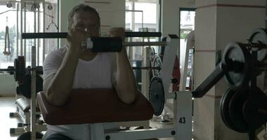 Senior man exercising on bicep training machine video