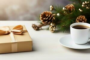 Gift box in craft paper with bow and fir branch, cup on the table. Holiday greeting card. photo