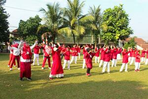 Bogor-Indonesia, August 17, 2023. photo of women doing gymnastics wearing red and white uniforms in field in celebration of Indonesia's Independence Day on August 17