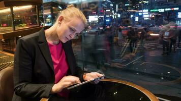 Time lapse shot of woman sitting in cafe using touch pad on the city background Seoul, South Korea video