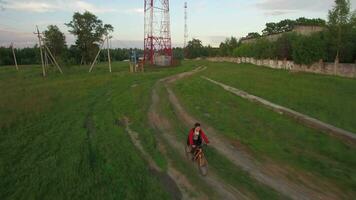 Aerial view of boy riding bike in the countryside video