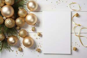 Christmas background with blank paper and golden decorations on a wooden table. photo