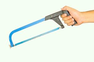 Hand holding hacksaw, background on white photo