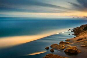 el playa a puesta de sol con rocas y agua. generado por ai foto