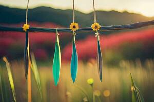 three colorful feathers hanging from a wire in a field. AI-Generated photo