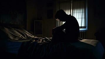 Deprimido hombre sentado cabeza en manos en el cama en el oscuro dormitorio, solitario y infeliz concepto. generativo ai foto