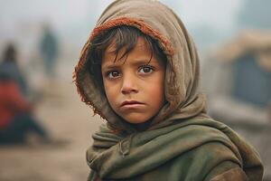 A poor staring hungry orphan boy in a refugee camp with a sad expression on his face and his face and clothes are dirty and his eyes are full of pain. Generative Ai photo