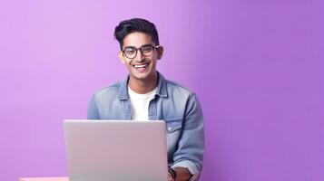 A happy Indian guy with laptop computer working or studying online on lilac background. Generative Ai photo