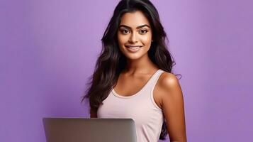 A happy Indian woman with laptop computer working or studying online on lilac background. Generative Ai photo