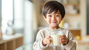 Asian little boy cute kid holding a cup of milk, feel happy enjoy drinking milk  in kitchen. Generative Ai photo