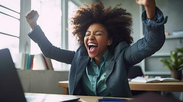 Joyful african american business woman freelancer entrepreneur Gesturing with her hands rejoicing in victory. in victory while sitting at desk after working finishing project at home. Generative Ai photo