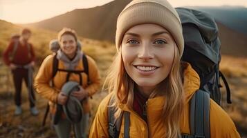 a Smiling young woman hiker with backpack looking at camera with group of friends hikers rises to the top of the hill. Hiker, Tourist camp. Generative Ai photo