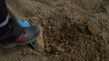 a person wearing black shoes and a blue shovel video