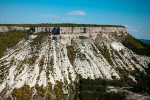 Mountain valley immersed in the greenery of the relict forest in Crimea near the city of Bakhchisarai and the ancient city of the Crimea Chufut-Kale. photo