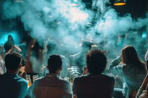 People are sitting in a hookah lounge in a nightclub. A company of friends with their backs against the background of smoke from a cigarette in a bar. photo