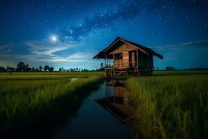 landscape view of a hut in the middle of a rice field with a milky way. long exposure photography. generative ai photo