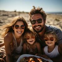 Cheerful family enjoying a picnic on the sandy shore photo
