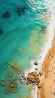 Aerial shot of a crowded beach with swimmers enjoying the waves photo