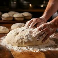 Flour-covered hands forming dough into perfect round shapes photo