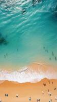 Aerial shot of a crowded beach with swimmers enjoying the waves photo