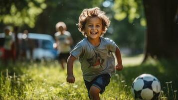 Kids having fun playing soccerfootball on the grass photo