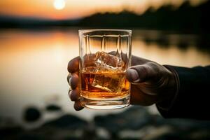 A close up of a male hand elegantly gripping a glass of whiskey AI Generated photo