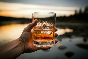 A whiskey aficionado's hand, captured in a gripping closeup with the glass AI Generated photo