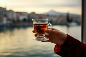 Enjoying Turkish tea, a woman takes in the scenic Bosphorus Bay AI Generated photo