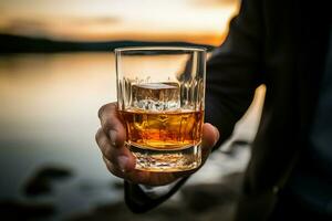 Intriguing closeup Male hand firmly holds a glass of smooth whiskey AI Generated photo