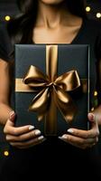 Chic display Gift card, box held by female hands on black wooden table. Vertical Mobile Wallpaper AI Generated photo