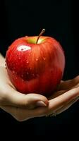 Detailed shot Womans hand grasping an apple, highlighting its vibrant presence Vertical Mobile Wallpaper AI Generated photo