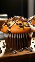 Irresistible chocolate chip muffin a sweet and comforting bakery delight Vertical Mobile Wallpaper AI Generated photo