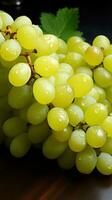 An abundance of Shine Muscat grapes, both whole and sliced, on a white surface Vertical Mobile Wallpaper AI Generated photo